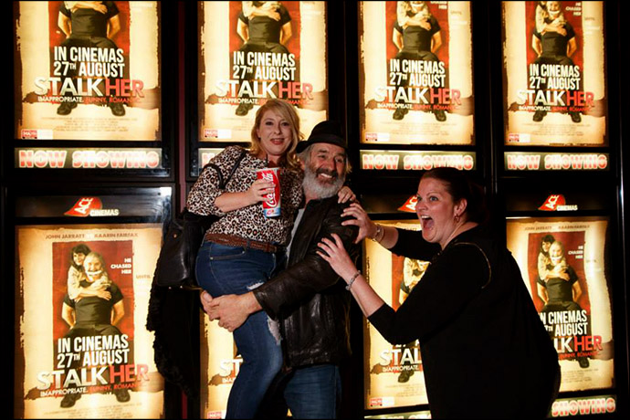 John Jarrat and Fans in front of a bank of Stalkher Film Posters John Jarrat and Fans in front of a bank of Stalkher Film Posters